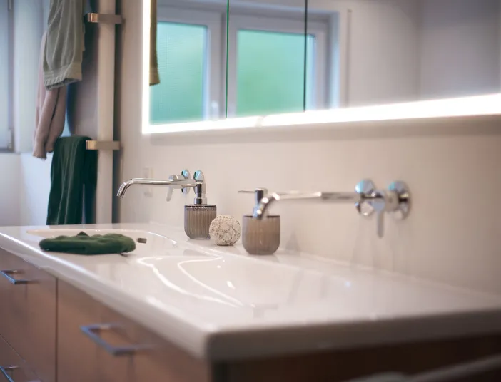 Hochwertiger Badezimmer-Waschtisch mit zwei Waschbecken und minimalistischen Wandarmaturen.
